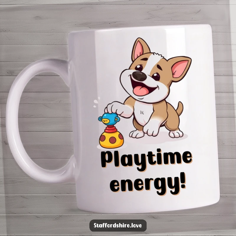 Funny mug showing a happy Staffordshire dog pouncing playfully at a toy, full of canine energy and fun.