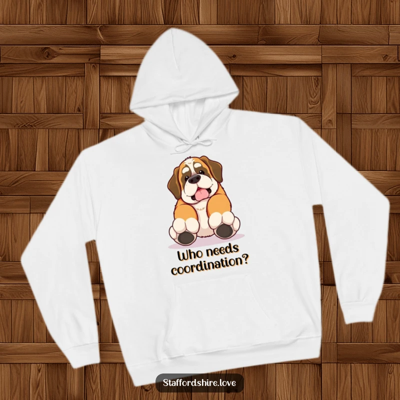 Funny hoodie with a kawaii Saint Bernard tripping over its own large paws, comfortable and endearing.