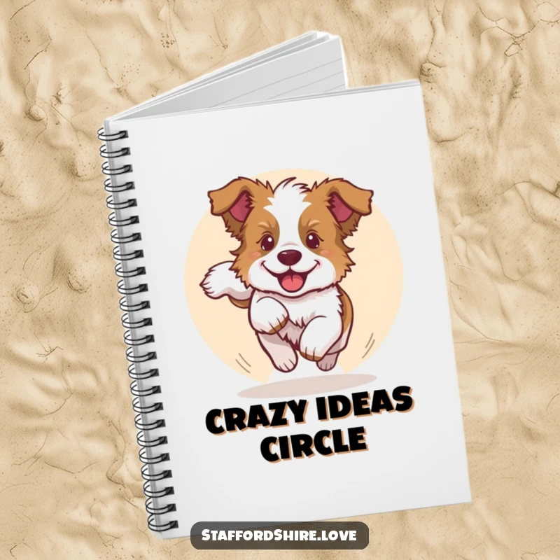 Funny notebook cover showcasing a Staffy puppy joyfully chasing its tail, perfect for jotting down energetic thoughts humorously.