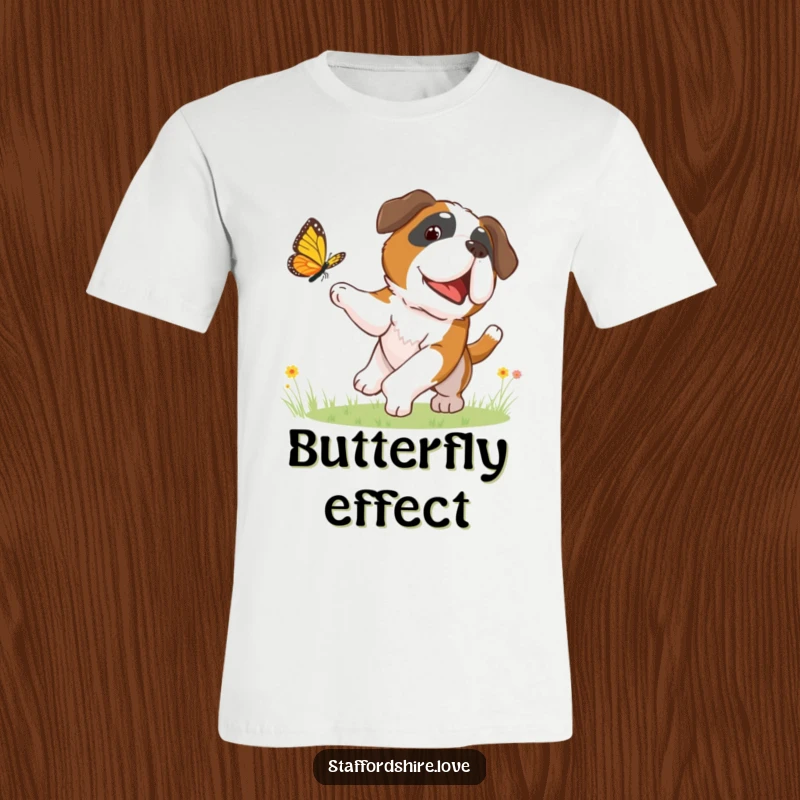 Funny t-shirt depicting a happy Saint Bernard dog enthusiastically chasing a fluttering butterfly in a field of flowers.