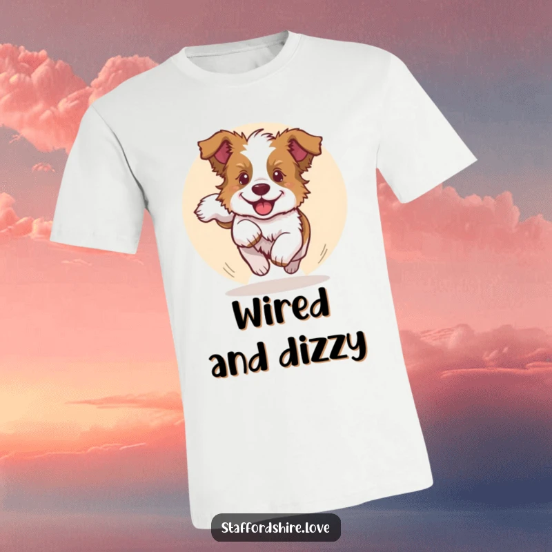 Funny t-shirt depicting a playful Staffordshire bull terrier puppy joyfully chasing its tail in a circle, radiating pure happiness.
