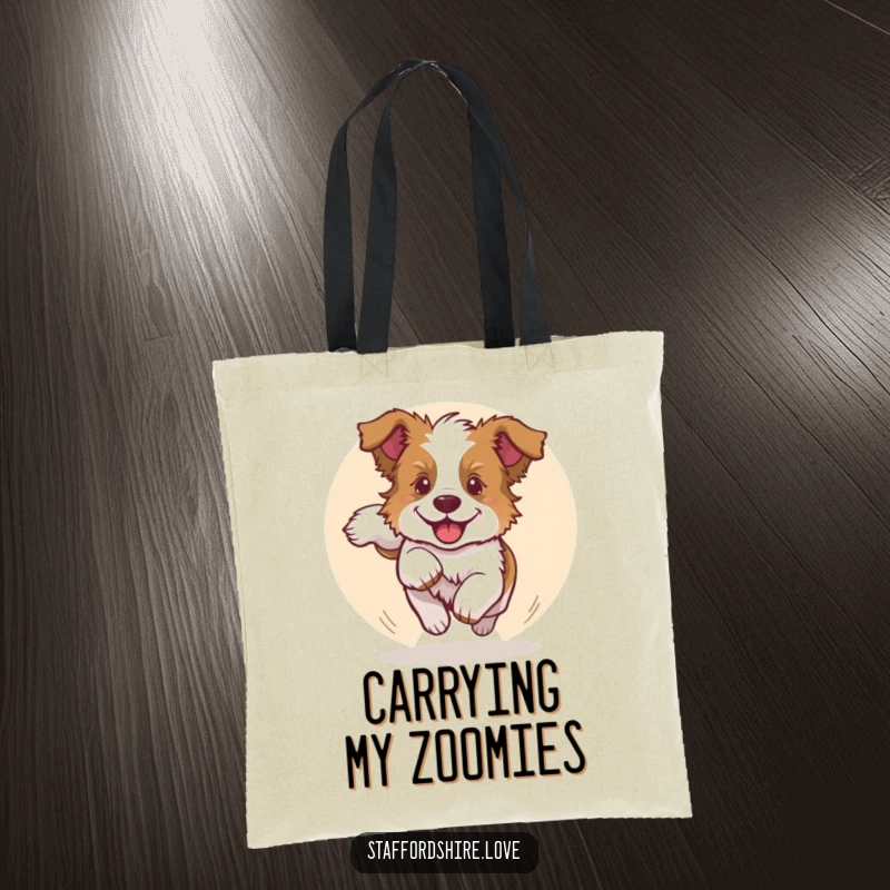 Funny tote bag showcasing a Staffordshire bull terrier puppy joyfully chasing its tail, perfect for carrying items with canine charm.
