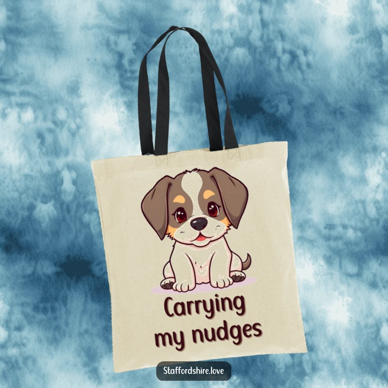 Funny kawaii Staffordshire puppy with floppy ears, playfully nudging on a tote bag, for carrying humor and dog love.