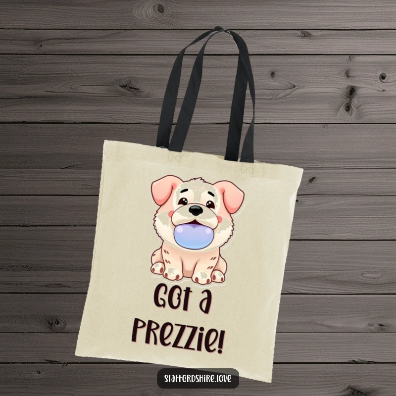 Funny Kawaii Staffordshire tote bag showing an enthusiastic dog offering a slobbery toy, ideal for carrying daily items with joy.