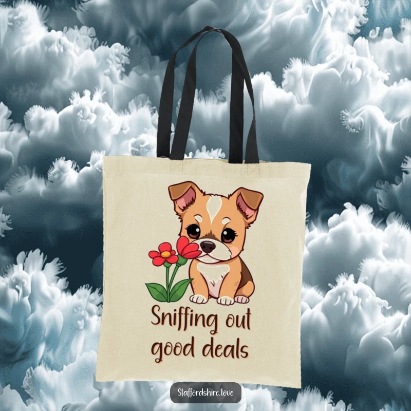 Funny Staffordshire dog tote bag showcasing a curious dog with wide eyes, sniffing a red flower, perfect for carrying your discoveries.